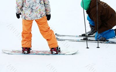 Snowboarder and skier