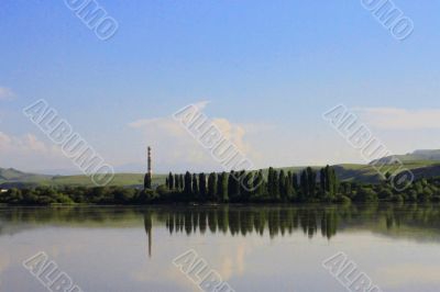 Calm lake and low mountains behind it