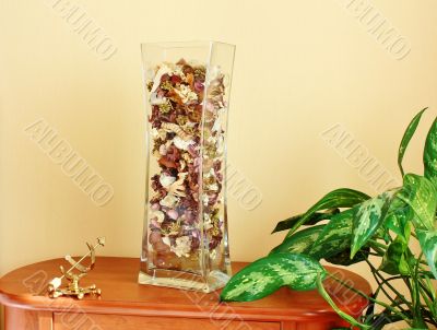 Glass vase filled with flower petals