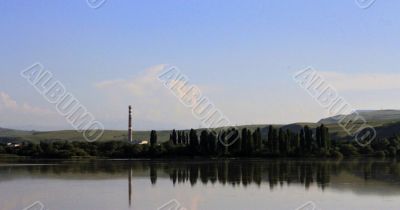 Calm lake and low mountains behind it