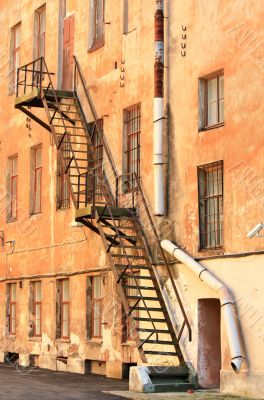 Metal ladder at the wall of the house