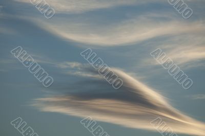 Diagonal clouds on blue sky