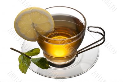 tea cup with lemon and leaves on a saucer