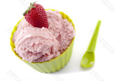 close up image of strawberry in green cup with green spoon
