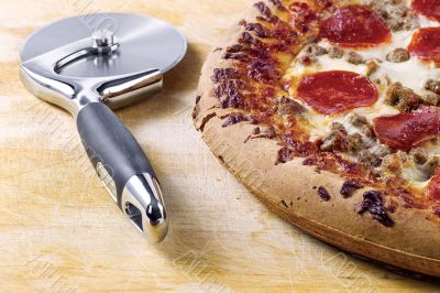 pizza cutter and pizza