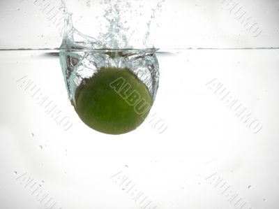 fresh lime falling into water