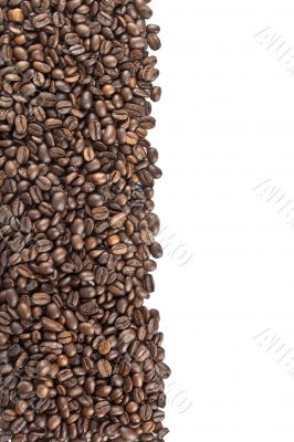 roasted coffee beans on a white surface 