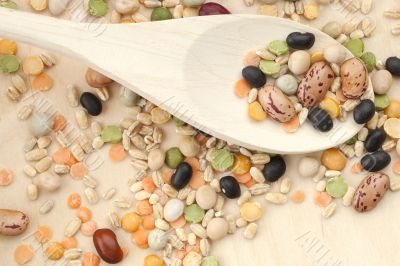 assorted beans in wooden spoon