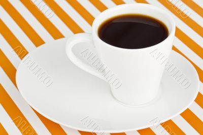 a mug of dark coffee on a saucer