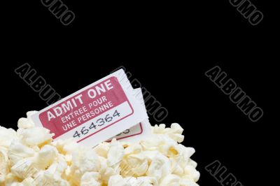closed up popcorn with tickets