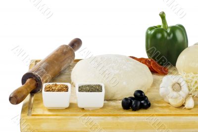 rolling pin dough and pizza ingredients