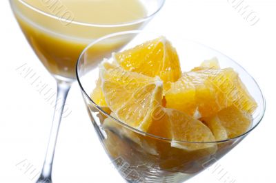 two martini glass with orange juice and orange slice