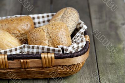 cropped image of assorted bread in basket