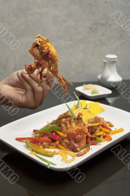 human hands and crab dish