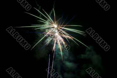 a mix of blue green and yellow fireworks
