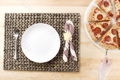 white plate waiting for the slice on pizza