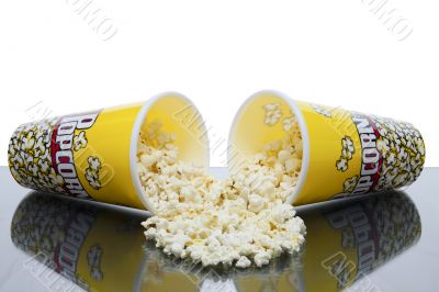 two cups of spilled popcorn