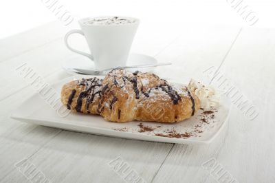 chocolate flavor croissant with coffee on the side