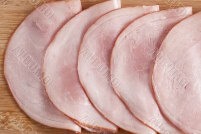 slices of uncooked ham on the plate