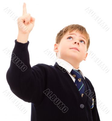 Schoolboy in hip uniform points upwards.