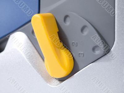 close up image of electric saw base adjustment button