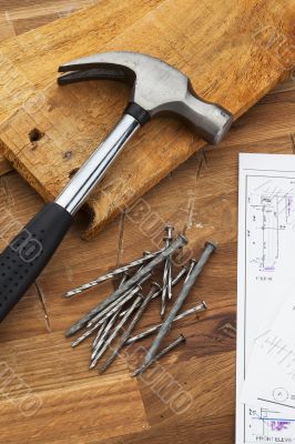 hammer on table with nails