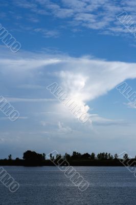 view of calm sea with clouds in background