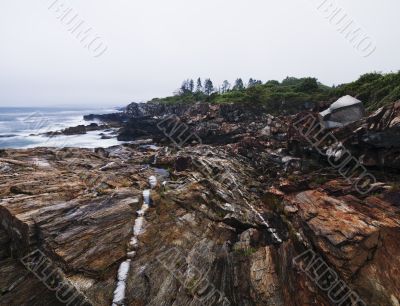 rock formation and sea with cliff in background