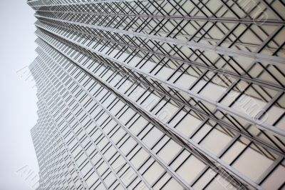 low angle shot of a tall commercial building with steel frames