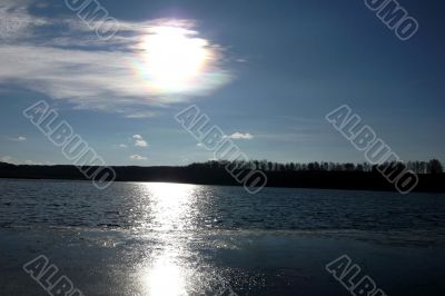 Lake and sky with sun.