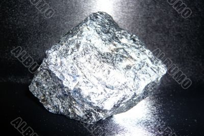 Silvery shiny stone on a black background.