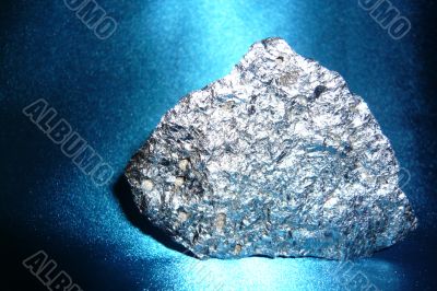 Silvery stone on blue shiny background.