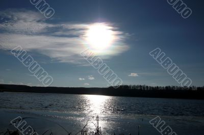 Lake and sky with sun.