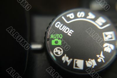 Macro image of a digital camera`s controls set on auto