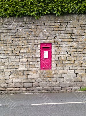 red postbox in a wall