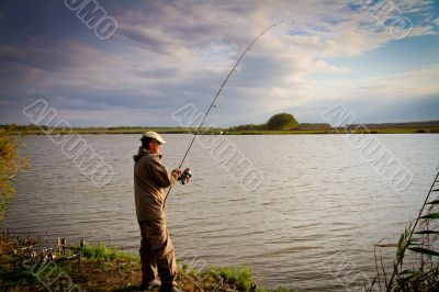 fisher with rod near the river