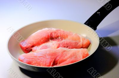 the meat in frying pans