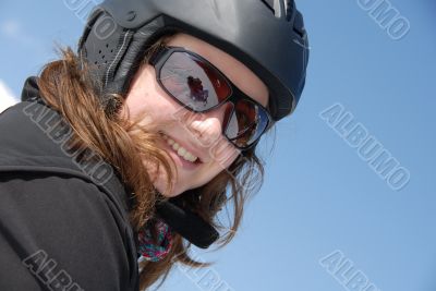 Portrait of a smiling young woman wearing ski helmet