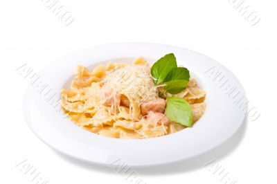 a plate of pasta decorated with basil