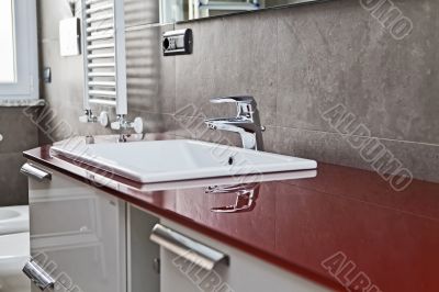 Red bathroom faucet reflection