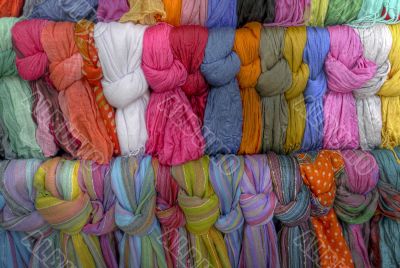 Many scarves on a stand waiting for buyers