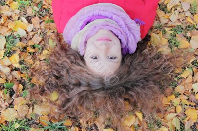 Young woman with autumn leaves