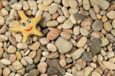 Plasticine star on sea shingle