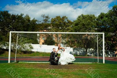 Bride and groom on the football field