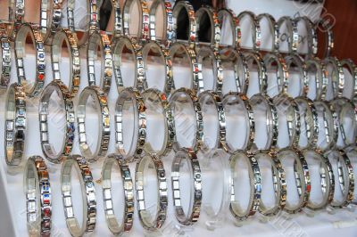 Many different metal bracelets together.
