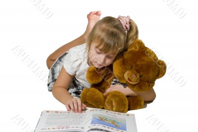 Beautiful little girl playing with a bear. 