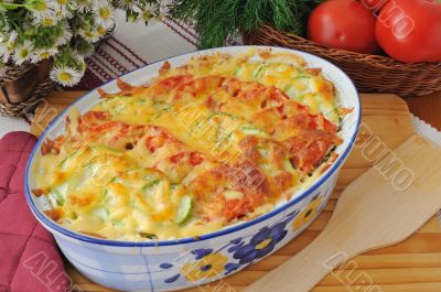 casserole of pasta with zucchini and tomato with cheese