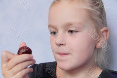Beautiful small girl eating sweetmeat
