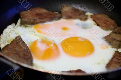 Fried eggs and meat for breakfast