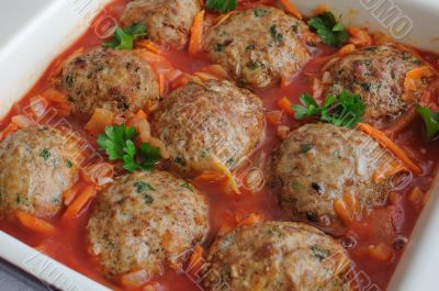 Meatballs with herbs and tomato sauce in the pan